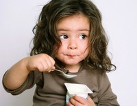 девочка кушает йогурт