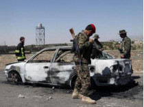 Афганские полицейские возле взорванной машины