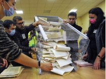 Бюллетени вынимают из урны на избирательном участке