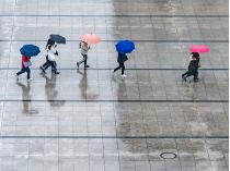 Люди під парасольками